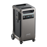 The Anker Solix F3800 is a portable power station with intelligent energy monitoring, a digital display, control buttons, multiple ports, side vents, wheels for easy transport, and an expandable capacity in a sleek gray rectangular design with rounded edges.