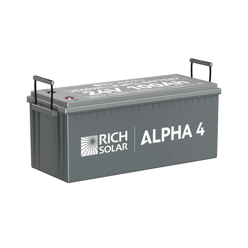 A gray rectangular Rich Solar LiFePO4 battery, labeled ALPHA 4, has black side handles and white lid text showing 12V 100Ah. It comes with a 5-year warranty.