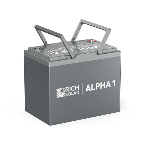 A gray Rich Solar ALPHA 1 LiFePO4 Battery, featuring two metal handles on top and labeled as a 12.8V 100Ah lithium battery, is shown against a white background.