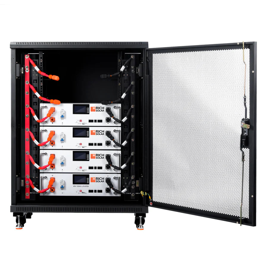 A black server rack with an open mesh door reveals four stacked Rich Solar LiFePO4 battery modules with digital displays, connected by orange and black cables—an advanced energy storage system for green energy solutions.