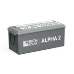 A gray rectangular Rich Solar ALPHA 2 battery with a handle, labeled 12.8V 200Ah on top, designed for solar energy storage and ideal for pairing with solar panels or a 2000W inverter.