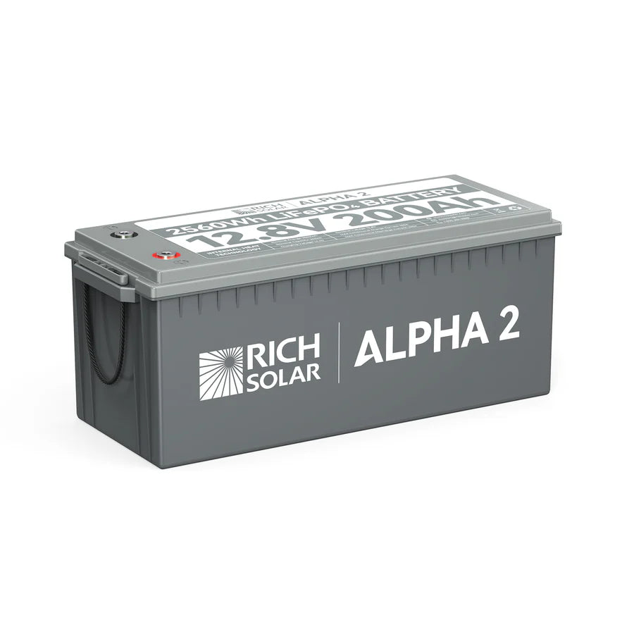 A gray rectangular Rich Solar ALPHA 2 battery with a handle, labeled 12.8V 200Ah on top, designed for solar energy storage and ideal for pairing with solar panels or a 2000W inverter.