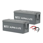 Two large gray Rich Solar ALPHA 2 LITE 200Ah LiFePO4 batteries are shown side by side, with one red and one black cable placed in front.