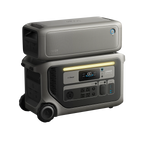 The Anker portable power station features a digital display, multiple outlets, wheels, and an extra battery stacked on top. The grey devices are designed for mobile energy use and provide reliable emergency backup power.