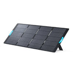 A portable black Anker solar panel with six rectangular sections, blue handles on each side, and stands angling it on a white background—ideal for off-grid power or emergency backup needs.