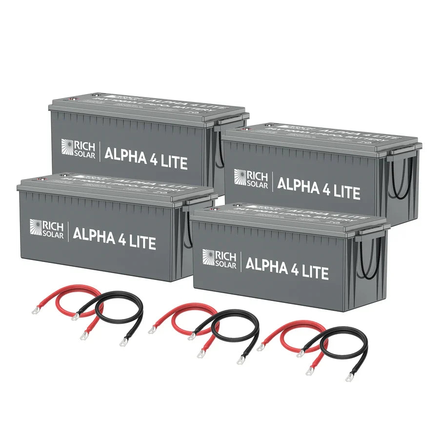 Four large gray Rich Solar ALPHA 4 LITE LiFePO4 batteries are arranged in two rows, with four sets of red and black connecting cables in front. Each battery supplies 2,560Wh for dependable power storage.