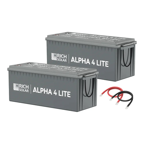 Two large gray Rich Solar ALPHA 4 LITE LiFePO4 batteries are shown side by side with black carrying handles and visible terminals. Included are one red and one black connector cable for a total of 2560 Watt Hours of power.