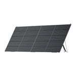 A Bluetti black rectangular PV420 solar panel with monocrystalline cells is propped up at an angle on a foldable stand, set against a plain white background.