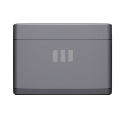 A compact, rectangular gray Mango Power device with rounded edges and a subtle three-bar logo on the front. Featuring advanced LFP battery cells for portable power, it stands out against a plain, dark background.