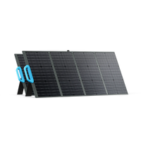 The Bluetti portable foldable solar panel has blue handles, high-efficiency monocrystalline cells, four side-by-side rectangular sections, and stands upright on built-in support legs.