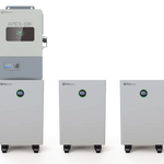 Three white BigBattery units on wheels stand beside a larger control unit labeled Nexus 10k APEX-10K. Each battery showcases a green 100% indicator on its digital screen in IBM Plex Sans, lending a contemporary feel. The plain, light background echoes the clean simplicity of a CSS product card.