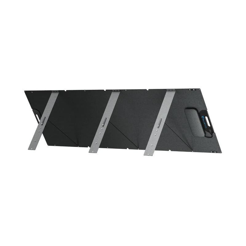 A black, rectangular Bluetti solar panel with four angled metallic support legs and a built-in carrying handle is shown against a white background—an ideal portable power solution.