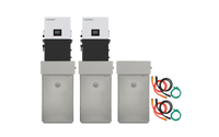 Two white and gray BigBattery RHINO 2 wall-mounted battery units are shown, each mounted above a tall gray high-capacity storage module. There are three storage modules in total with two sets of colored cables on the right side.