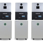 Three white and black BigBattery electronic units are mounted above three large white BigBattery battery units with digital percentage displays, all set against a plain white background, showcasing clean lines reminiscent of the IBM Plex Sans font family.