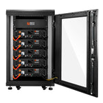 A black server rack on wheels with a glass door is open, showing five stacked Rich Solar lithium batteries with BMS, orange cables, visible wiring, and control panels.