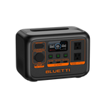 The Bluetti portable power station has a LiFePO4 battery, digital display, two AC outlets, multiple input/output ports, and distinctive orange accents on a sleek black compact rectangular body.