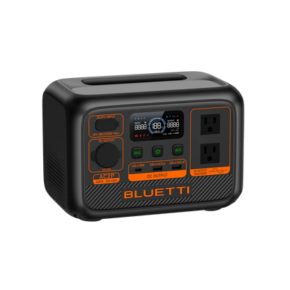 The Bluetti portable power station has a LiFePO4 battery, digital display, two AC outlets, multiple input/output ports, and distinctive orange accents on a sleek black compact rectangular body.