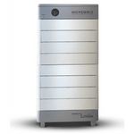 The Homegrid battery system is a tall, rectangular, silver and gray home power unit with a modular design featuring horizontal segments and a circular indicator at the top left. The HOMEGRID brand name appears on the top panel.