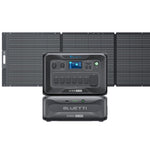 Bluetti portable power station with LiFePO₄ battery, control panel, display, and multiple outlets sits atop a B300 module with UPS protection, pictured before a foldable solar panel array.