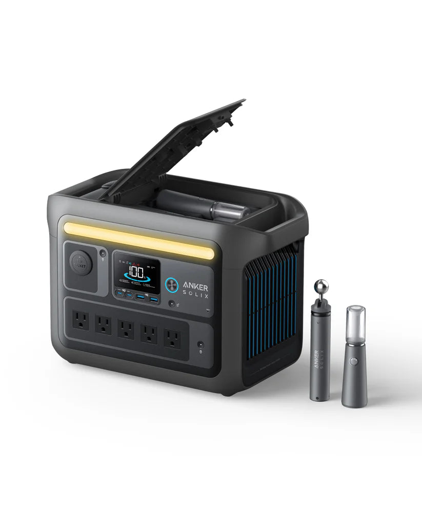 An Anker portable power station with a digital display, four AC outlets, and storage space under an open lid. Powered by LiFePO4 batteries, its perfect for devices or camping lights. Two metallic cylinders are placed beside it on a white background.