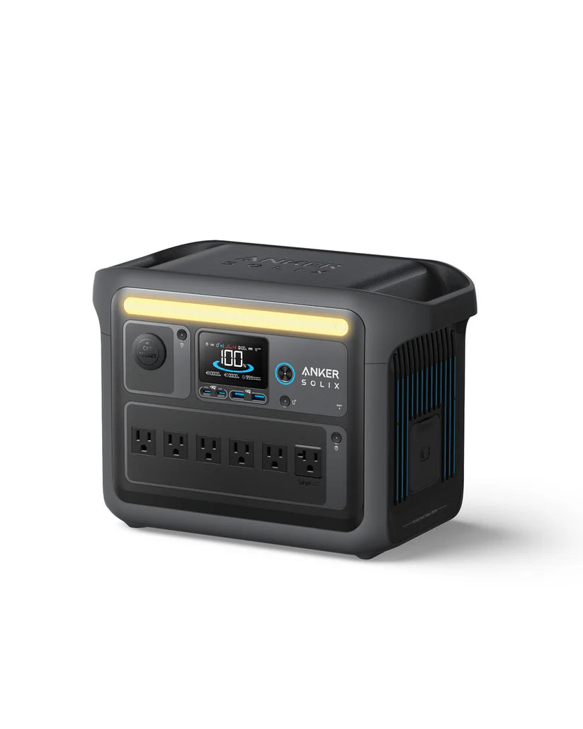 An Anker SOLIX C1000X portable power station in black, featuring a digital display, four AC outlets, and a built-in handle, is displayed against a white background.