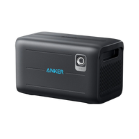 A black Anker BP2600 Expansion Battery portable power station, displaying a blue Anker logo, power button, vented side panel, carrying handle, and reliable LiFePO4 batteries, is pictured against a white background.