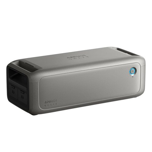 A portable rectangular gray Anker Bluetooth speaker with a mesh front, power button, dual side ports, and textured finish—perfect for off-grid or emergency audio use.