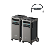 Two Anker SOLIX F3800 portable power stations with wheels and handles are displayed side by side. Above them is a black accessory with a display and two connectors. Each unit features reliable LiFePO4 battery technology, ensuring dependable power wherever you go.