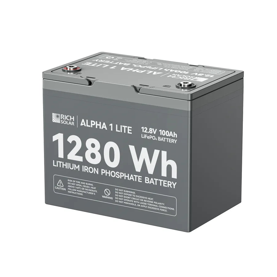 A gray rectangular Rich Solar lithium iron phosphate battery labeled ALPHA 1 LITE, 1280Wh, 12.8V 100Ah LiFePO4, with caution and usage details printed on its surface.