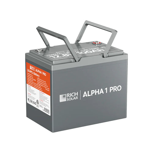 A gray Rich Solar ALPHA 1 PRO 12.8V 100Ah LiFePO4 Battery featuring two handles, top terminal posts, and an orange product details label on the front left side.