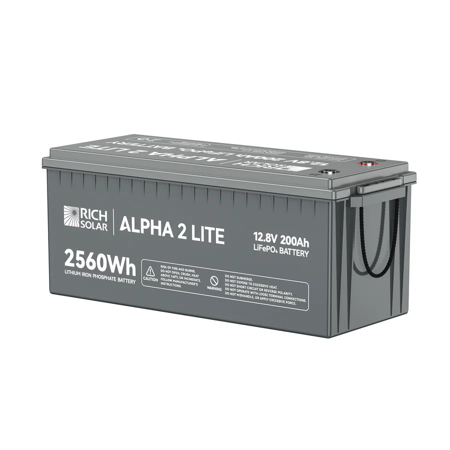 A gray rectangular Rich Solar ALPHA 2 LITE LiFePO4 Battery, 12.8V 200Ah (2560Wh), with side handles, product labels, and specs printed on its surface.