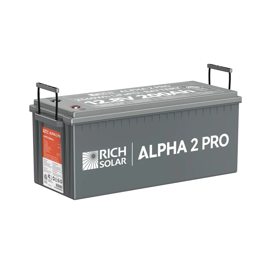 A rectangular gray Rich Solar ALPHA 2 PRO 12.8V 200Ah LiFePO4 Battery with black handles and a red-and-white label; its 2560Wh capacity is clearly marked on the lid for easy identification.