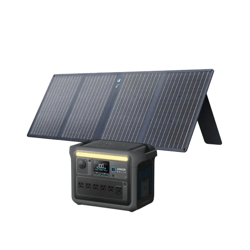 An Anker portable solar panel is angled behind the Anker SOLIX C1000X Portable Power Station, which features multiple outlets and a digital display on its front.