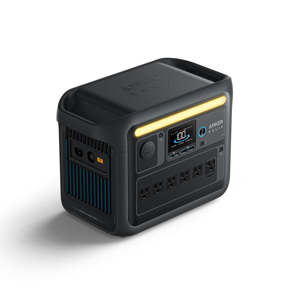 An Anker SOLIX C1000X black portable power station featuring a yellow light strip, digital display, multiple buttons, ports, and AC outlets on the front, displayed against a white background.