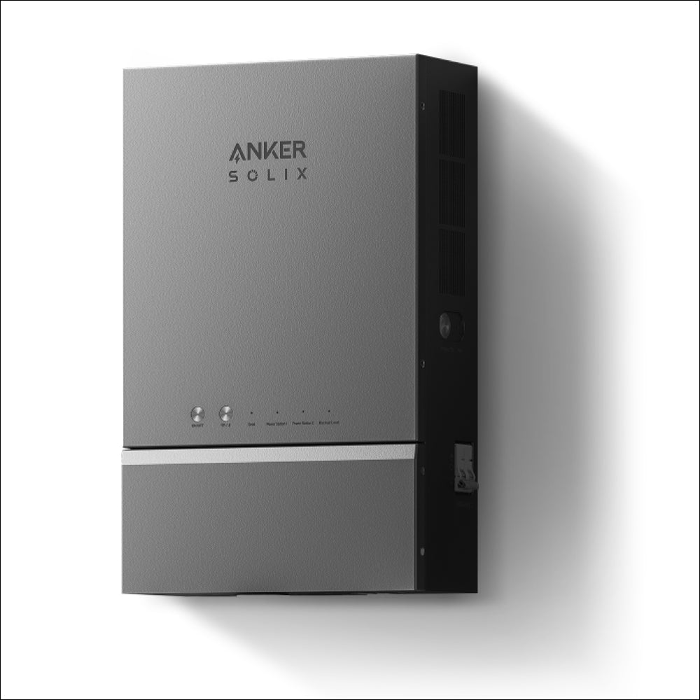 A gray wall-mounted Anker home power panel with indicator lights and buttons on the front, casting a right-side shadow on a white wall—perfect for backup power or solar integration.