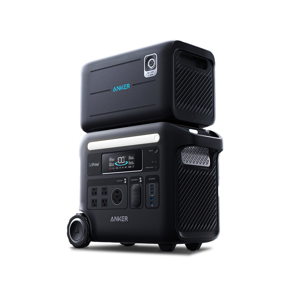 A black Anker portable power station with a detachable battery pack stacked on top, multiple ports, solar input, control buttons, a display screen, and a carrying handle is shown on a white background.