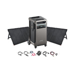 Anker portable power station with digital display, two foldable solar panels behind it, plus multiple charging cables and connectors in front—an ideal off-grid energy solution, all displayed on a white background.