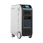 A white and black Bluetti EP500 Pro backup power station features wheels, a handle, various power outlets, and a digital display screen on the upper front panel.
