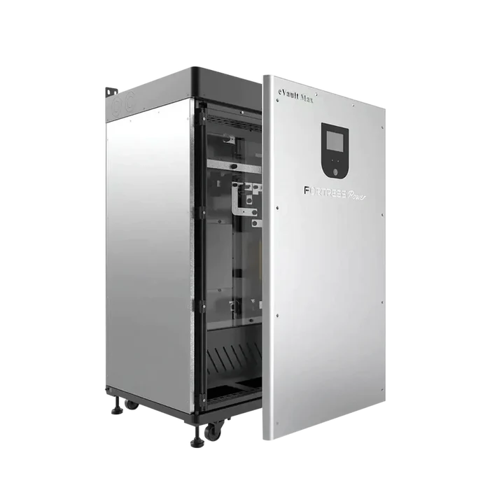 A silver and black Fortress Power electronic cabinet stands on four wheels with its door open, showing internal components. The front panel features a screen and the words “Fortress Power eVault Max”; this unit is an LFP battery energy storage system.