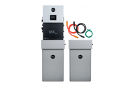 Two tall, rectangular gray EG4 battery units appear next to a black control panel with digital display. Red, black, and green cables are coiled nearby, showcasing a complete EG4 home energy storage system against a white background.
