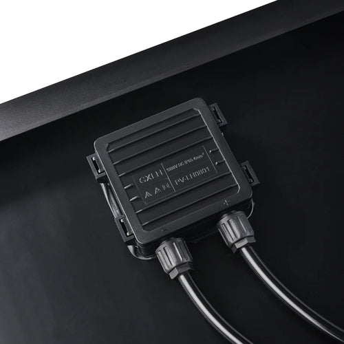Close-up of a Rich Solar black electrical junction box with two cables attached, mounted on a flat black surface—ideal for off-grid solar trailers or portable solar charging kits. Technical info and symbols are displayed on the box.