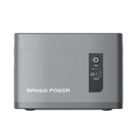 A gray rectangular Mango Power portable power station labeled Mango Power E features a power button, indicator lights, USB ports, and a round input port on the control panel—ideal for use with an expansion battery.