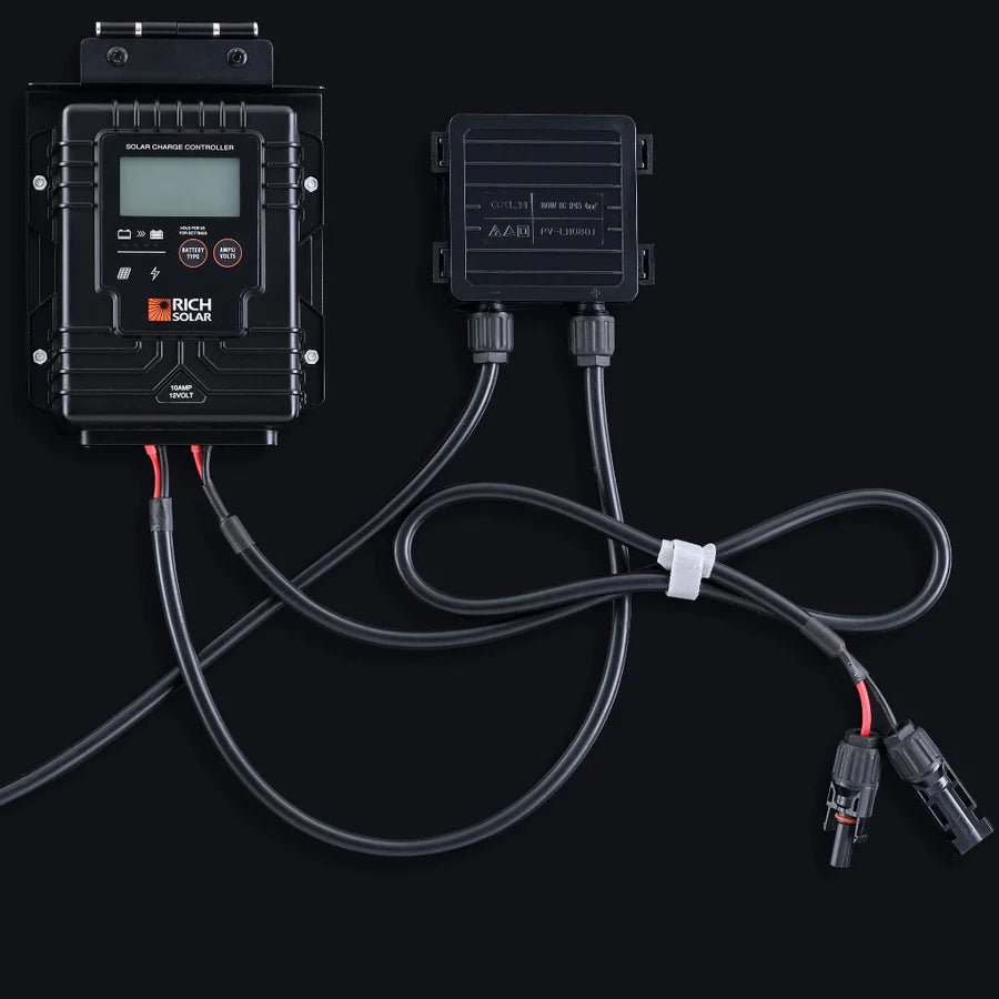 A black Rich Solar charge controller and junction box are connected by MC4 cables, essential for any RV solar setup, all shown on a dark background.