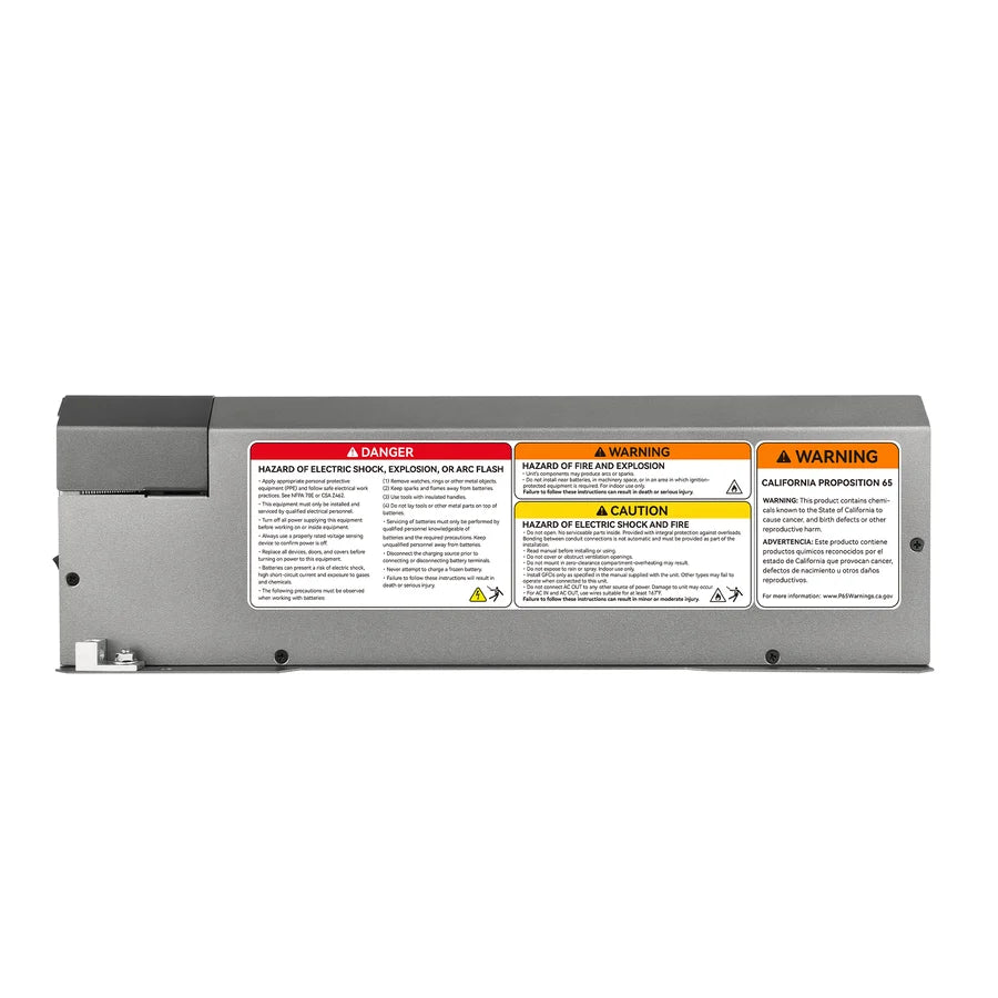 Rectangular battery pack with various warning and caution labels about electric shock, explosion, and fire hazards. The labels are in red, yellow, and orange, with text in black on a gray metal surface. The sharp edges of the pack contrast with the smooth border-radius of some label designs, while subtle box-shadow effects help important warnings stand out for enhanced visibility.