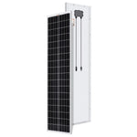 A Rich Solar black-and-white rectangular compact solar panel stands upright; the front shows a grid of cells, while the back displays its white surface with an attached junction box and two cables.
