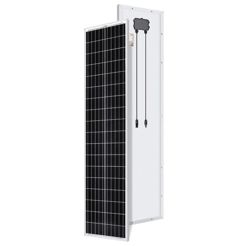 A Rich Solar black-and-white rectangular compact solar panel stands upright; the front shows a grid of cells, while the back displays its white surface with an attached junction box and two cables.