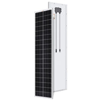 A Rich Solar black-and-white rectangular compact solar panel stands upright; the front shows a grid of cells, while the back displays its white surface with an attached junction box and two cables.