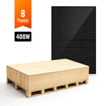 A large wooden shipping crate sits on a pallet in front of a black monocrystalline solar panel. An orange label above reads 8 Panels, with 400W below—ideal for off-grid solar applications.