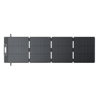 A foldable, four-panel Bluetti solar charger is fully unfolded and laid flat, displaying its grid-like monocrystalline cells and fast-charging connectors on one end.