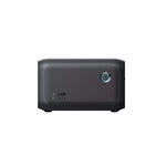 The Anker SOLIX BP1000X is a compact, rectangular black portable power station featuring a textured side panel, circular blue front power button, and expansion battery built for an impressive 10-year lifespan.